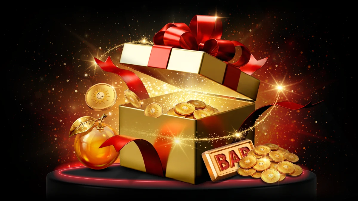 Goldene Geschenkbox mit Münzen und roter Schleife